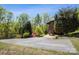 Long driveway leading to a well-maintained home surrounded by mature trees and landscaping at 3605 Ridgetop Rd, Sherrills Ford, NC 28673