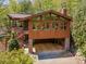 A garage sits under a beautiful home that has an elevated deck and gorgeous landscaping at 3605 Ridgetop Rd, Sherrills Ford, NC 28673