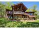Exterior elevation of a two-story home featuring wood and brick with landscaped yard at 3605 Ridgetop Rd, Sherrills Ford, NC 28673