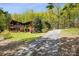 Beautiful home exterior features a long driveway, lush landscaping, and mature trees at 3605 Ridgetop Rd, Sherrills Ford, NC 28673