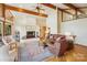 Spacious living room featuring a cozy fireplace, wood floors and forest views at 3605 Ridgetop Rd, Sherrills Ford, NC 28673