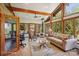 Cozy living room with large windows offering views of the surrounding greenery, fireplace, and vaulted ceilings at 3605 Ridgetop Rd, Sherrills Ford, NC 28673