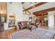 Open concept living room with vaulted ceilings, exposed beams, and an adjacent kitchen at 3605 Ridgetop Rd, Sherrills Ford, NC 28673