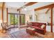 Inviting living room featuring wood beams, a sliding glass door, and tile flooring at 3605 Ridgetop Rd, Sherrills Ford, NC 28673
