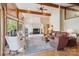 Spacious living room with vaulted ceilings, exposed beams, and a cozy fireplace at 3605 Ridgetop Rd, Sherrills Ford, NC 28673