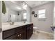 Well-lit bathroom with double sinks, tile flooring, and a shower at 4013 Highgate Ln # 2B-78, Lancaster, SC 29720