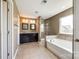 Bright bathroom showcasing a soaking tub, glass shower, and dual sinks at 4013 Highgate Ln # 2B-78, Lancaster, SC 29720