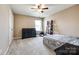 Cozy bedroom features carpet flooring, neutral walls, ceiling fan, and a large window at 4013 Highgate Ln # 2B-78, Lancaster, SC 29720