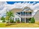 Charming two-story home with a well-manicured lawn, stone accents, and inviting front porch and balcony at 4013 Highgate Ln # 2B-78, Lancaster, SC 29720