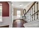 Elegant foyer with hardwood floors, staircase, and decorative mirror creating a welcoming entry at 4013 Highgate Ln # 2B-78, Lancaster, SC 29720