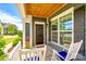 Covered porch featuring rocking chairs, wood ceiling detail, and views of the front yard at 4013 Highgate Ln # 2B-78, Lancaster, SC 29720