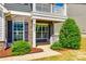 Inviting front porch with stone accents, white railings, and a cozy seating area with rocking chairs at 4013 Highgate Ln # 2B-78, Lancaster, SC 29720
