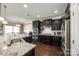 Modern kitchen featuring granite countertops, dark cabinetry, and stainless steel appliances for cooking at 4013 Highgate Ln # 2B-78, Lancaster, SC 29720