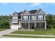 Charming two-story home with a stone and gray siding exterior, landscaped yard, and inviting front porch at 408 Balboa St, Matthews, NC 28104