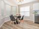 Cozy dining area with modern lighting, sleek black chairs, and a view from the bright bay windows at 4628 Arthur Way, Rock Hill, SC 29732