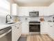 Modern kitchen with black hardware and faucet fixtures, white cabinets, countertops, and subway tile backsplash at 4628 Arthur Way, Rock Hill, SC 29732