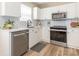 Modern kitchen features white cabinets, stainless steel appliances, and wood-look flooring at 4628 Arthur Way, Rock Hill, SC 29732