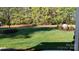 Beautifully landscaped backyard with lush green lawn and mature trees at 472 Bellingshire Dr, Mt Ulla, NC 28125