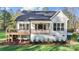 Rear exterior view of home with deck, and well-manicured lawn at 472 Bellingshire Dr, Mt Ulla, NC 28125