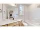 Well-lit bathroom with modern vanity, white countertop, and a tub-shower combo at 472 Bellingshire Dr, Mt Ulla, NC 28125