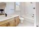 Bright bathroom with a wooden vanity, white countertop, and tub-shower at 472 Bellingshire Dr, Mt Ulla, NC 28125
