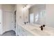 Bright bathroom featuring double vanity sinks with modern fixtures and ample counter space, and stylish tile floors at 472 Bellingshire Dr, Mt Ulla, NC 28125
