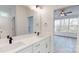 Bathroom featuring double vanity sinks with modern fixtures and ample counter space, and a view to the bedroom at 472 Bellingshire Dr, Mt Ulla, NC 28125