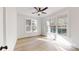 The bright, airy bedroom features hardwood floors and natural light from large windows with wooded views at 472 Bellingshire Dr, Mt Ulla, NC 28125