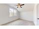 Bright bedroom featuring a ceiling fan, large window, and neutral carpet at 472 Bellingshire Dr, Mt Ulla, NC 28125