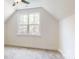 Sun-filled bedroom has ample natural light from a large window, with neutral carpet and white walls at 472 Bellingshire Dr, Mt Ulla, NC 28125
