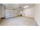 Clean garage with an automatic door and concrete flooring at 472 Bellingshire Dr, Mt Ulla, NC 28125