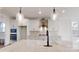 Modern kitchen with white cabinets, stainless steel appliances, a large island, and stylish pendant lighting at 472 Bellingshire Dr, Mt Ulla, NC 28125
