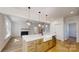 Open kitchen with island connects to the living room featuring a fireplace for easy entertaining at 472 Bellingshire Dr, Mt Ulla, NC 28125