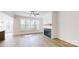 Inviting living room with hardwood floors, a cozy fireplace, and large windows overlooking the backyard at 472 Bellingshire Dr, Mt Ulla, NC 28125