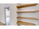 These are custom wood shelves and a glimpse into the home's open floor plan and design at 472 Bellingshire Dr, Mt Ulla, NC 28125