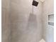 Modern walk-in shower is beautifully tiled and features rainfall shower head, built-in niche, and sleek fixtures at 472 Bellingshire Dr, Mt Ulla, NC 28125