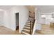 Elegant staircase with hardwood steps and modern railings connecting to the main living area at 472 Bellingshire Dr, Mt Ulla, NC 28125