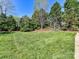 Expansive lawn and manicured landscaping, creating a serene and picturesque outdoor space for relaxation and recreation at 7012 Chadwyck Farms Dr, Charlotte, NC 28226