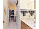 Hallway with bathroom vanity featuring neutral tile, and access to main bedroom beyond at 7012 Chadwyck Farms Dr, Charlotte, NC 28226