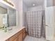 Bathroom featuring a single sink vanity, large mirror and a shower tub at 7012 Chadwyck Farms Dr, Charlotte, NC 28226