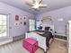 Charming bedroom with lilac walls, plush carpeting, a ceiling fan, and bright, natural light at 7012 Chadwyck Farms Dr, Charlotte, NC 28226
