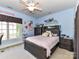 Bright bedroom featuring a ceiling fan, blue walls, and a cozy bed near a window at 7012 Chadwyck Farms Dr, Charlotte, NC 28226