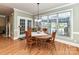 Sunlit dining area with round table, large windows, and access to the outside at 7012 Chadwyck Farms Dr, Charlotte, NC 28226