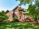 Beautiful brick home with well-manicured lawn and lush landscaping at 7012 Chadwyck Farms Dr, Charlotte, NC 28226
