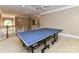 Bright game room boasting a full-size ping pong table under a ceiling fan and crown moulding at 7012 Chadwyck Farms Dr, Charlotte, NC 28226