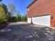 Spacious three-car garage with a large driveway and a beautiful brick facade, perfect for car enthusiasts or families at 7012 Chadwyck Farms Dr, Charlotte, NC 28226