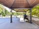 The outdoor gazebo on a wooden deck offers a serene setting, perfect for relaxation and entertainment with a grill at 7012 Chadwyck Farms Dr, Charlotte, NC 28226