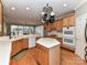 Spacious kitchen features an island, double ovens, and wooden cabinets at 7012 Chadwyck Farms Dr, Charlotte, NC 28226