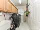 Functional laundry room equipped with a modern washer/dryer and storage cabinets at 7012 Chadwyck Farms Dr, Charlotte, NC 28226