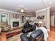 Cozy living room features a fireplace, plush seating, and hardwood floors at 7012 Chadwyck Farms Dr, Charlotte, NC 28226